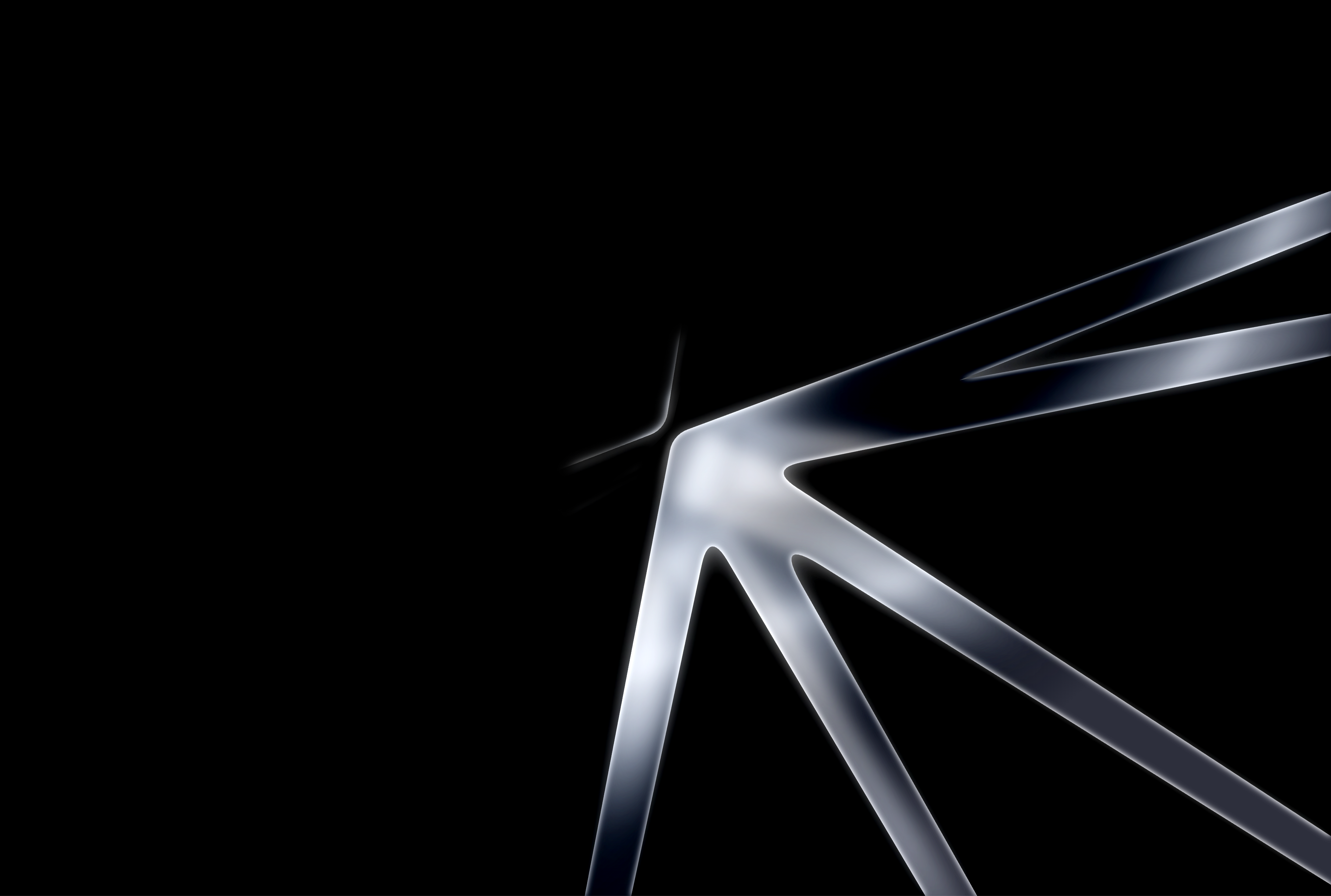 Close-up of a luminous glass shape on a black background